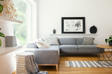Black and white textiles and decorations in a classic scandinavian style living room interior with...