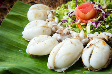 Grilled baby cuttlefish on wood plate. Thailand local seafood. Abundance of food resources of Asia concept. image for menu list and advertisement.