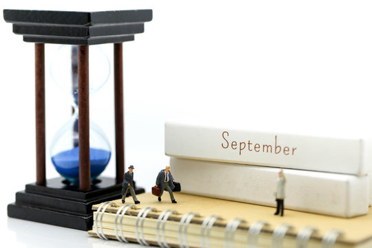 Miniature people : Businessman look a watch using for concept of time and Be Late For Something Day.