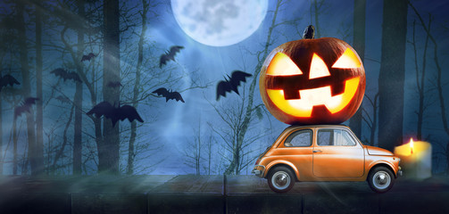 Halloween car delivering pumpkin against night scary autumn forest background - 221390109