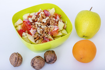 Fruit bowl with sliced apples oranges and nuts