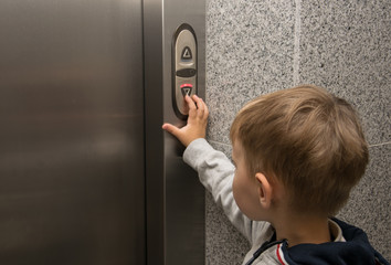 The little boy is calling the elevator. © Konstiantyn Zap