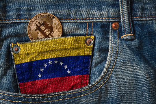 Golden BITCOIN (BTC) cryptocurrency in the pocket of jeans with the flag of United Arab Emirates on Jeans Denim Texture.