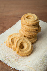 Butter cookies on white linen on wooden table.