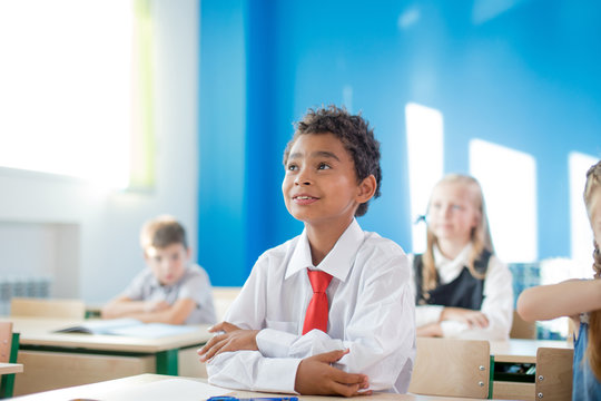 Black School Boy Sittiing In Classroom At Desk