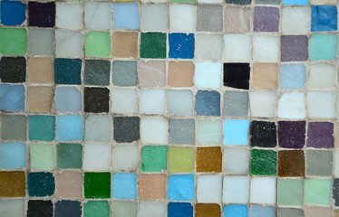 Background old colorful mosaic wall for copy space backdrop. Squares different colour - green, blue, orange, red, white, black, grey