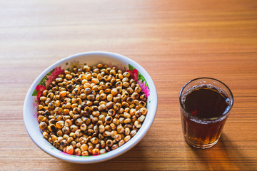 Fried Corn with Black Tea on the wooden Table