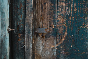 old wooden door. Rusty hook. brown background. place for text