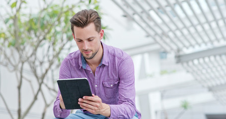 Man use of tablet computer at outdoor