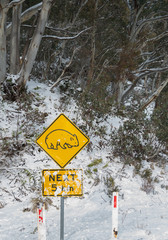 Wombat crossing caution sign in the snow