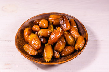 Date fruits on the white wooden table