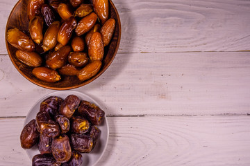 Date fruits on the white wooden table. Top view
