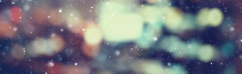 city lights snow glow background blurred / cityscape blurred bokeh, snowy weather seasonal background winter December