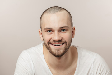 joyful unshaven ssportsman with beautyful blue eyes. athlete is happy to achieve good results in...
