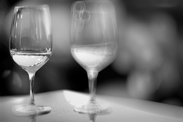 glass of white wine in the restaurant / white wine in the interior of the restaurant a table with glasses of wine, a romantic summer