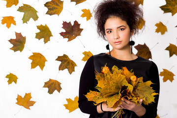 beautiful girl on a white background with autumn leaves