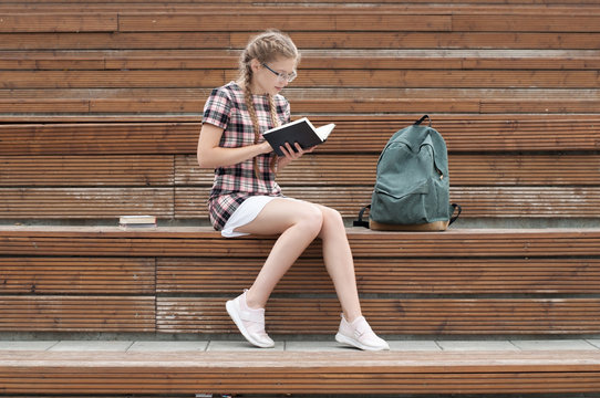cute nerd girl reading a book