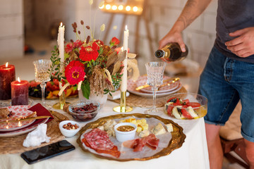Pouring champagne into a glass on some festive event or wedding reception.