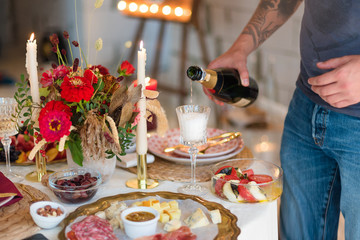 Pouring champagne into a glass on some festive event or wedding reception.
