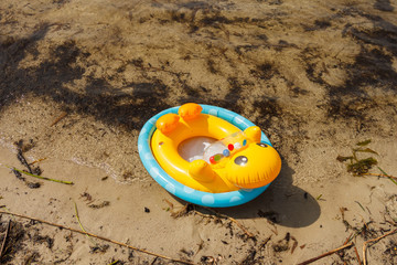 Inflatable children's swimming circle on the shore of the lake