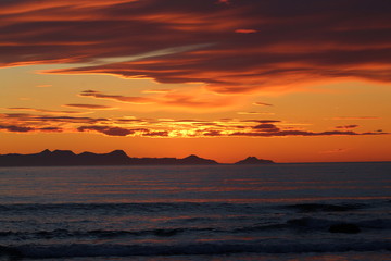 Fototapeta na wymiar Scenic sunset in Iceland, with orange burning sky. Zoom lens.