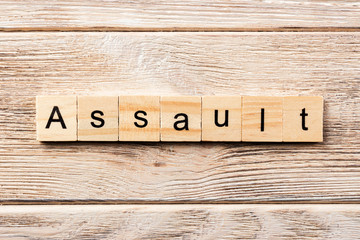 assault word written on wood block. assault text on table, concept
