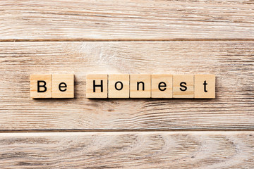 be honest word written on wood block. be honest text on table, concept - obrazy, fototapety, plakaty