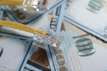 LAN cable on one hundred dollar bills. Internet price concept