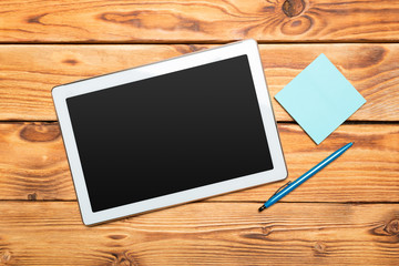 White digital tablet on wooden table