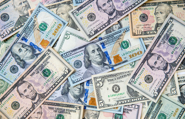 Money american hundred dollar bills Pile of various currencies isolated on white background.Closeup of assorted American banknotes.US currency scattered on the table.america currency dollor currency.