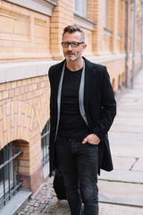 Portrait of mature, metro man walking on path