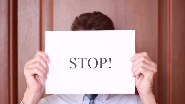 "Stop" inscription in front of male face