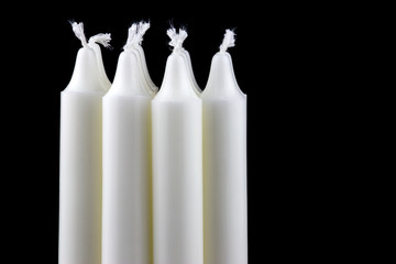White Candles Against a Black Background