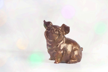 Pigs or boar on abstract light background. The effect of bokeh. Symbol of the New Year. The concept...