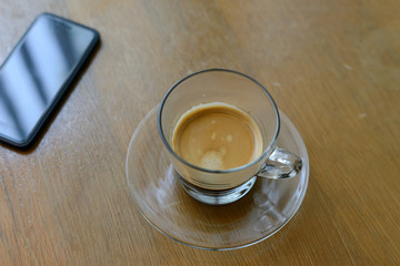 Black coffee in glass on wooden tabil for refreshment on the morning