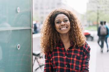 Street portrait of cheerful African American woman