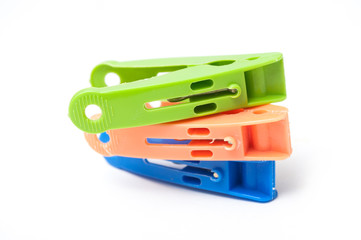 closeup of colorful plastic clothespins on white background