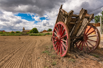 Old cart in a field to be cultivated