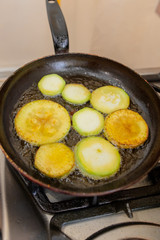Roast zucchini in the frying pan in the kitchen