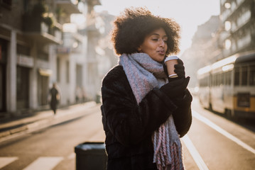 Beautiful girl with afro haircut walking on the street