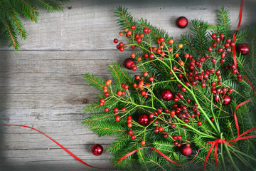 New Year background with Christmas tree, dogrose and red balls on the old wood background