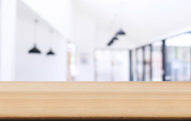 Empty wooden table and blurred background of abstract in front of coffee shop or restaurant for display of product or for montage