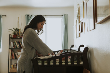 Mother changing a diaper on a newborn baby