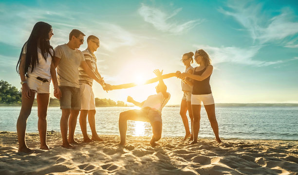 Happiness Friends funny game on the beach under sunset sunlight