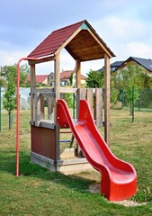 Empty red slide in the playground.
