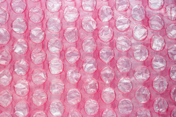 Layer of red used soft packaging film with burst air bubbles