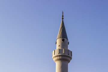 Clear shoot of old masonry minaret with blue sky background