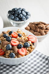Healthy breakfast concept with oat flakes and fresh berries on rustic background. Food made of granola and muesli. Healthy banana smoothie with blackberries, honey and milk.