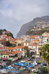 Obraz premium View of Câmara de Lobos in Madeira with Cape Girão on the background and boats at the marina