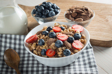 Healthy breakfast concept with oat flakes and fresh berries on rustic background. Food made of granola and muesli. Healthy banana smoothie with blackberries, honey and milk.